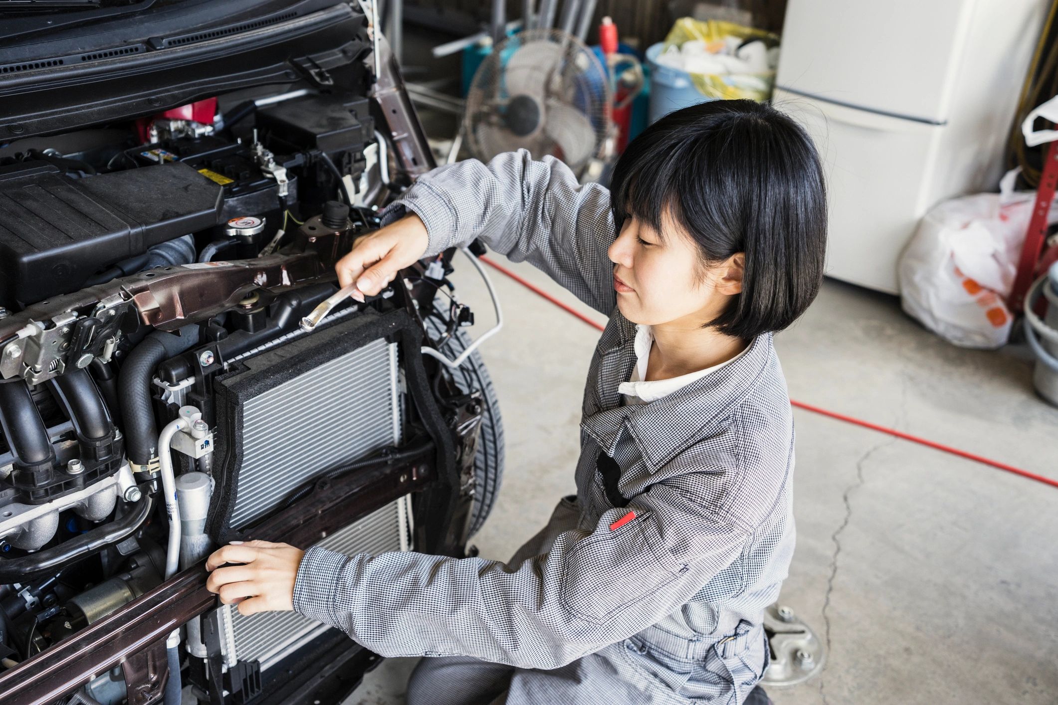 mechanic working on car engine Japanese